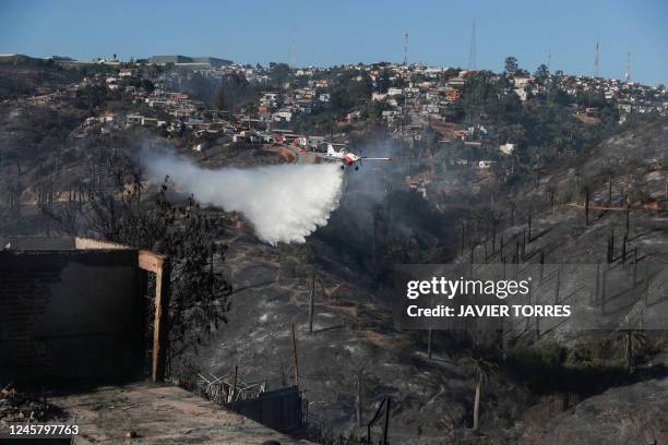 Light aircraft works in the area where a forest fire affected the hills of Viña del Mar, in the Valparaiso region, Chile, on December 23, 2022. - At...
