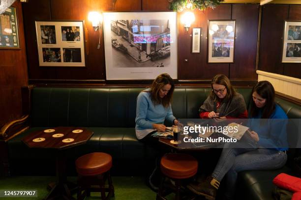 Group of tourists have a few pints of Guinness at the John Kehoe, an example of a traditional Dublin pub, with a beautiful Victorian bar and a...