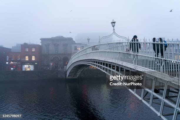 Foggy day view of the Ha'penny Bridge is a pedestrian bridge built in 1816 over the River Liffey, in Dublin .