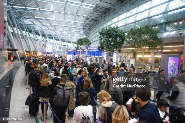 General view of a crowd of people waiting for the security check at Duesseldorf Airport in Germany on December 23rd ahead of the Christmas holiday is...