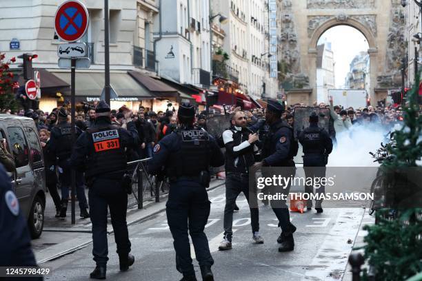 Protestors clashes with French riot police officers following a statement by French Interior Minister Gerald Darmanin at the site where several shots...