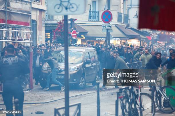 Protestors clashes with French riot police officers following a statement by French Interior Minister at the site where several shots were fired...