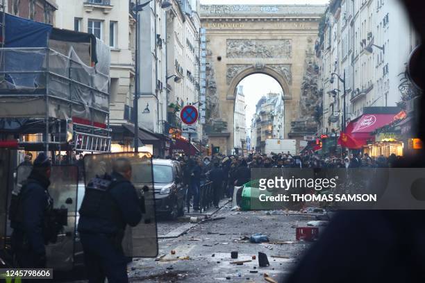 Protestors clashes with French riot police officers following a statement by French Interior Minister Gerald Darmanin at the site where several shots...