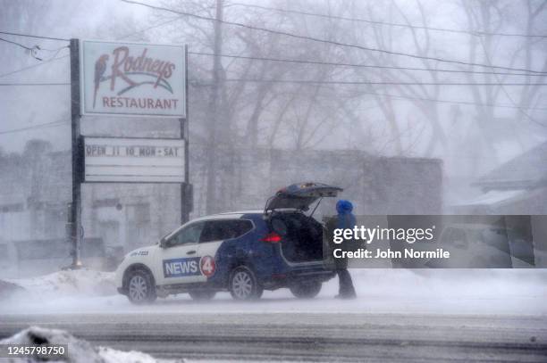 Member of the media battles snow and ice as Lake Erie waters wash over the shoreline on December 23, 2022 in Hamburg, New York. The Buffalo suburb...