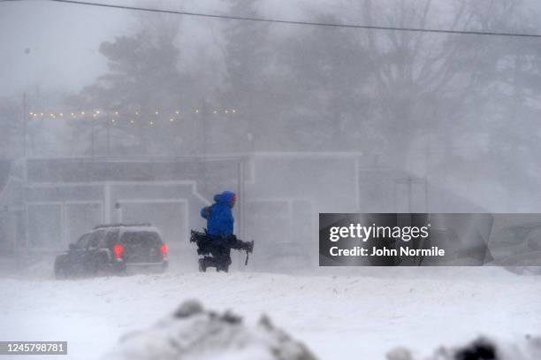 Member of the media battles snow and ice as Lake Erie waters wash over the shoreline on December 23, 2022 in Hamburg, New York. The Buffalo suburb...