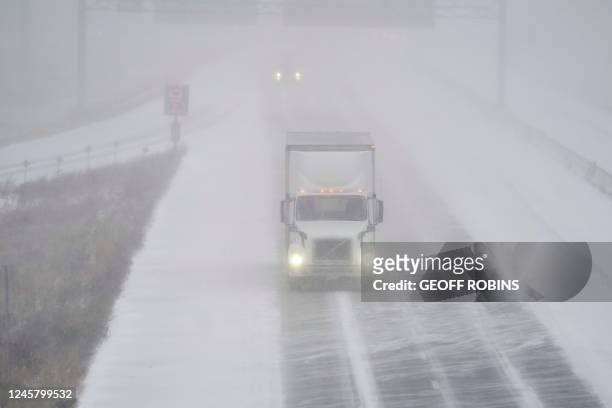 Transport truck drives along Highway 401 in London, Ontario, Canada, during a large winter storm on Friday, December 23, 2022. - Schools and some...