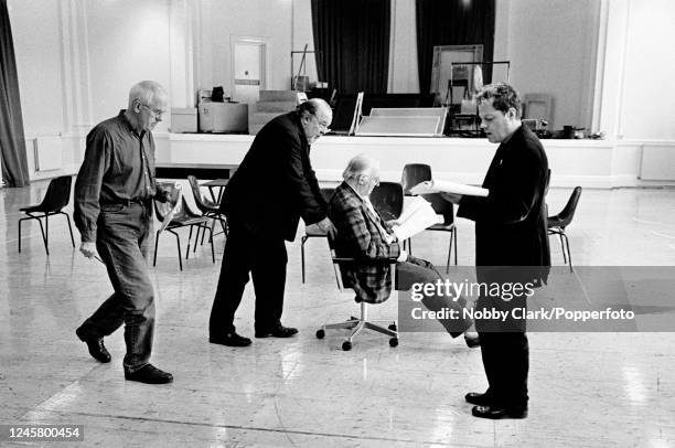 Sir Peter Hall is pushing David Ryall on an office chair as Eddie Izzard reads his lines during rehearsals for the West End play "Lenny" which opened...