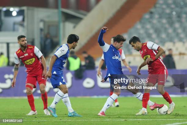 Vahid Amiri of Persepolis and Saeid Mehri of Esteghlal battle for the ball during the Persian Gulf Pro League match between Esteghlal and Persepolis...