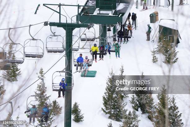 Skiers ride a lift at Deer Valley Ski Resort in Park City, Utah, on December 23, 2022.