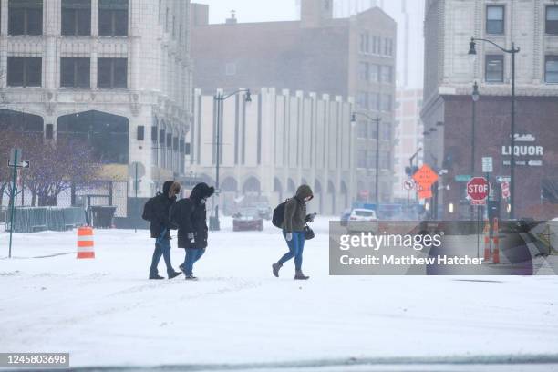 Detroit residents brave the frigid temperatures and heavy gusts of wind in downtown Detroit on December 23, 2022 in Detroit, United States. A major...