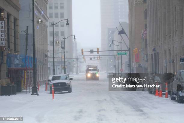 Snow removal vehicles try to clear roads in downtown Detroit on December 23, 2022 in Detroit, United States. A major winter storm swept over much of...