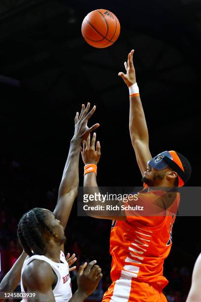 Andre Screen of the Bucknell Bison attempts a shot over Clifford Omoruyi of the Rutgers Scarlet Knights during the first half of a game at Jersey...