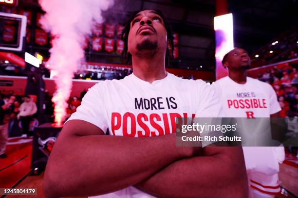 On the 50th anniversary of Title IX, Logan Stephens of the Rutgers Scarlet Knights along with his teammates wear commemorative shirts before a game...