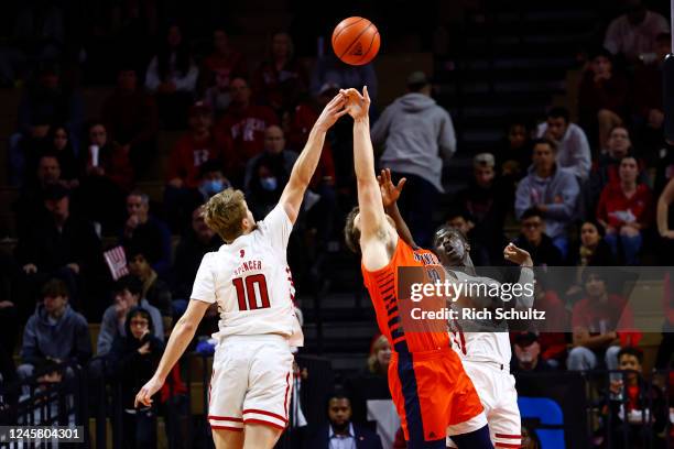 Cam Spencer and Mawot Mag of the Rutgers Scarlet Knights battle Alex Timmerman of the Bucknell Bison for a loose ball during the second half of a...