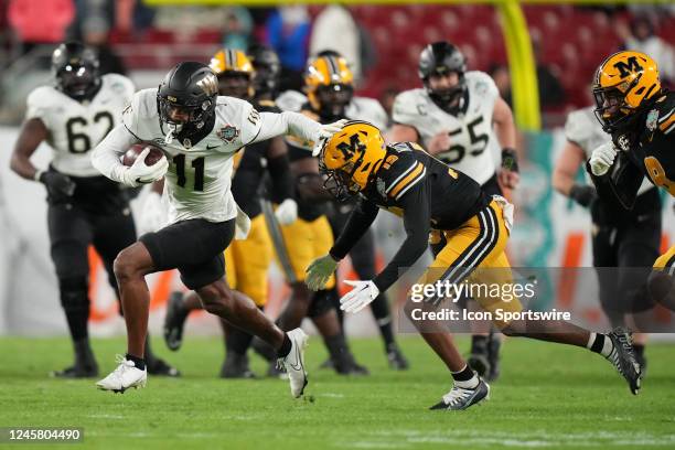 Wake Forest Demon Deacons wide receiver Donavon Greene truest fend off Missouri Tigers defensive back Daylan Carnell as he runs after a catch during...