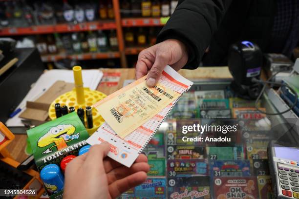 Cashier at a store hands a Mega Million lottery ticket to a person who plays in Burlingame, California, United States on December 23, 2022. Today's...