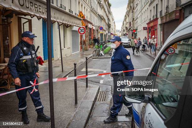 Police officers seen setting a cordon line for investigation. French police officers and paramedics arrive at a shooting scene in Rue d'Enghien,...