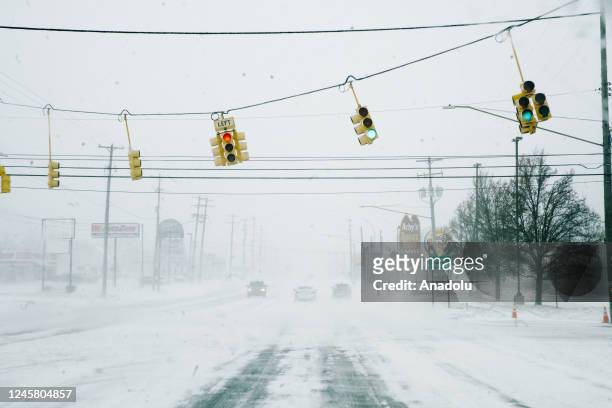 Street lights and snow blow in severe wind gusts during a massive winter storm affecting most of the USA., in Flint, MI on December 23, 2022.