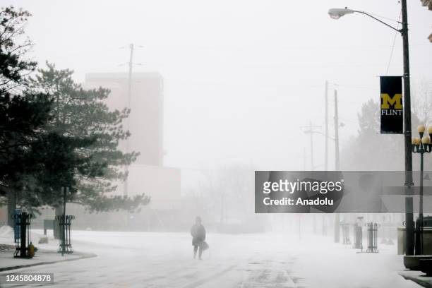 Woman walks through downtown Flint during a winter storm affecting most of the USA, in Flint, MI on December 23, 2022.