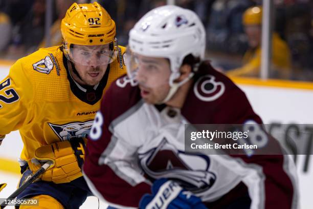 Ryan Johansen of the Nashville Predators defends against Alex Newhook of the Colorado Avalanche during the second period at Bridgestone Arena on...