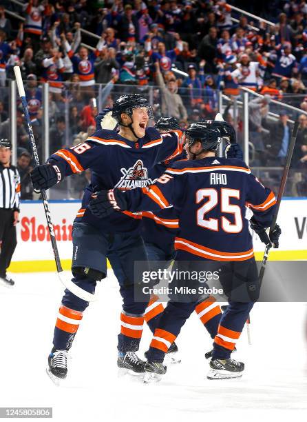 Aatu Raty of the New York Islanders is congratulated by Sebastian Aho after scoring his first career NHL goal against the Florida Panthers during the...