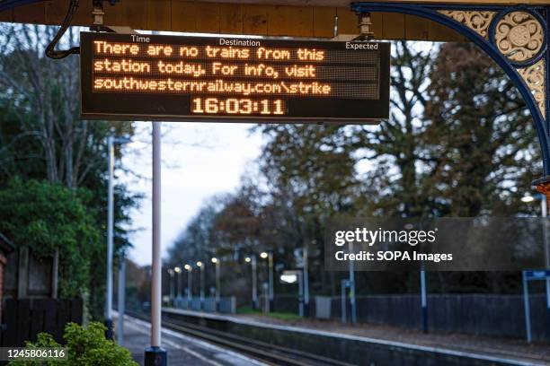 Deserted platform and a sign is seen announcing no trains at the station. It is part of the industrial action that is taking place in the U.K. That...