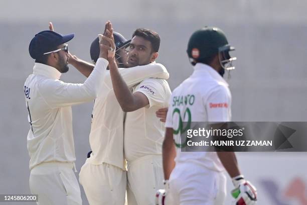 Indias Ravichandran Ashwin celebrates with his teammates after the dismissal of Bangladeshs Nazmul Hasan Shanto during the third day of the second...