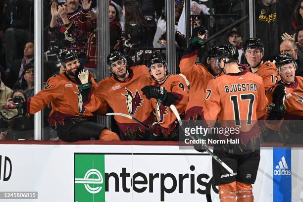 Nick Bjugstad of the Arizona Coyotes celebrates with teammates on the bench after scoring the shootout winning goal against the Los Angeles Kings at...