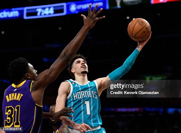 LaMelo Ball of the Charlotte Hornets drives to the basket against Thomas Bryant of the Los Angeles Lakers during the first half at Crypto.com Arena...