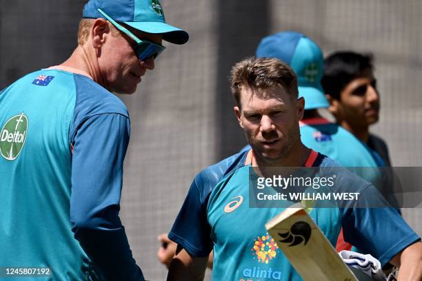 Australia's David Warner speaks with coach Andrew McDonald in the nets at the Melbourne Cricket Ground ahead of the second cricket Test match between...