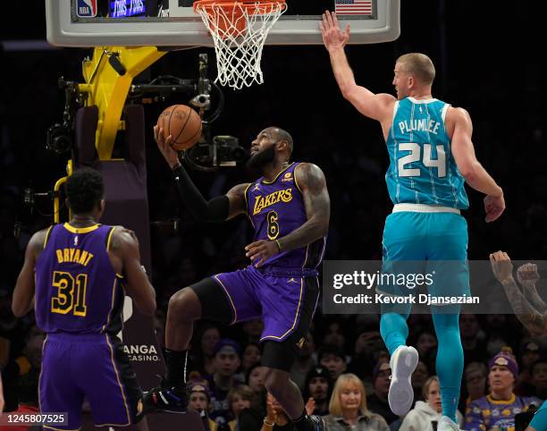 LeBron James of the Los Angeles Lakers scores a basket against Mason Plumlee of the Charlotte Hornets during the first half at Crypto.com Arena on...