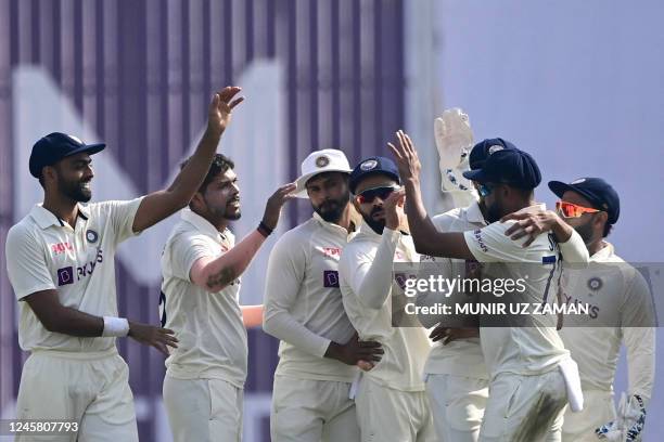 Indias cricketers celebrate after the dismissal of the Bangladeshs Jakir Hasan during the third day of the second cricket Test match between...