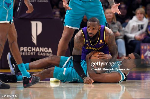 LeBron James of the Los Angeles Lakers is called with a foul on Theo Maledon of the Charlotte Hornets at Crypto.com Arena on December 23, 2022 in Los...