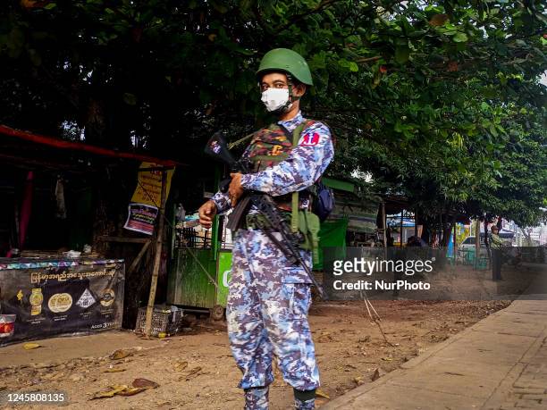 An armed navy soldier stands guard at the roadside during the visit of the Myanmar junta leader Min Aung Hlaing to Thanlyin township, on the...