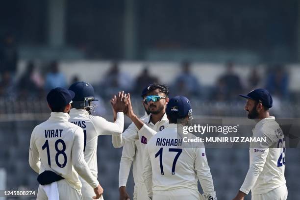 Indias cricketers celebrate after the dismissal of the Bangladeshs Mehidy Hasan Miraz during the third day of the second cricket Test match between...