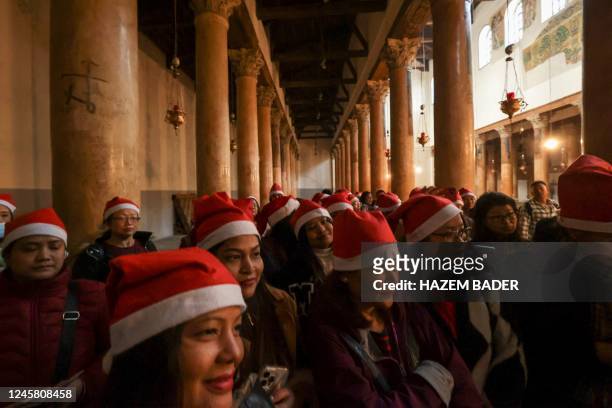 Tourists and pilgrims visit the Church of the Nativity in the biblical West Bank city of Bethlehem on December 24, 2022.
