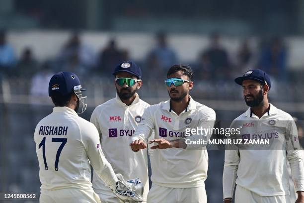 Indias cricketers celebrate after the dismissal of the Bangladeshs Mehidy Hasan Miraz during the third day of the second cricket Test match between...