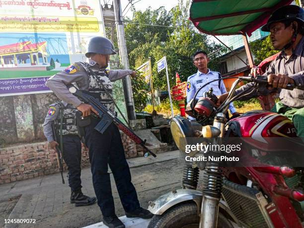 Armed policemen inspect a tricycle at a roadside checkpoint during the visit of the Myanmar junta leader Min Aung Hlaing to Thanlyin township, on the...