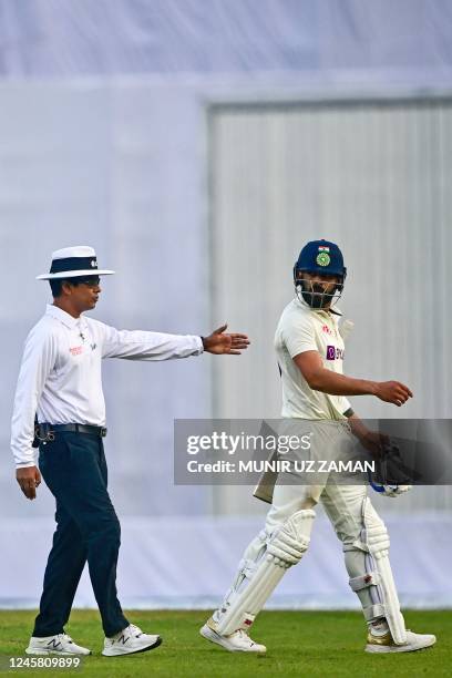 Indias Virat Kohli reacts after his dismissal by Bangladeshs Mehidy Hasan Miraz during the third day of the second cricket Test match between...