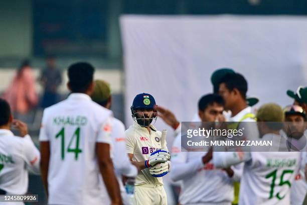 Indias Virat Kohli reacts after his dismissal by Bangladeshs Mehidy Hasan Miraz during the third day of the second cricket Test match between...