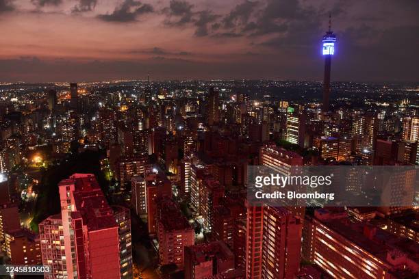 The Telkom Tower, right, surrounded by lit residential tower blocks and commercial buildings, viewed from the Ponte City Apartments building at...