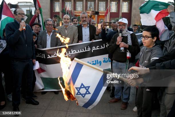 Moroccans burn the Israeli flag as they gather to protest the normalisation of ties with Israel, outside the parliament building in the capital Rabat...