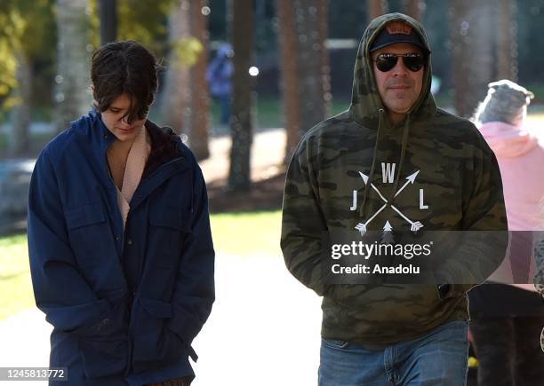 Young girl covers her ears to keep warm while walking with her family in Lake Eola Park on December 24, 2022 in Orlando, Florida. Freezing cold...