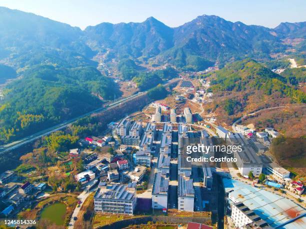 Dark blue photovoltaic panels are laid on the roofs of businesses and farm houses in Tengyun village, Anqing city, East China's Anhui province, Dec...