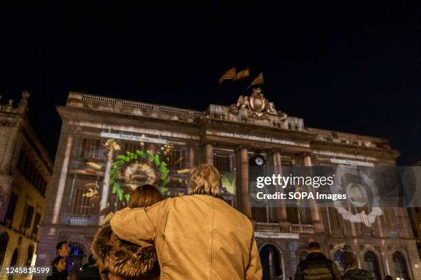 An embracing couple is seen contemplating the digital Nativity Scenes projected during Christmas eve 2022. The Barcelona City Council, led by Mayor...