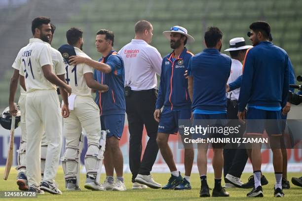 Indias coach Rahul Dravid congratulates Shreyas Iyer after winning on the fourth day of the second cricket Test match between Bangladesh and India at...