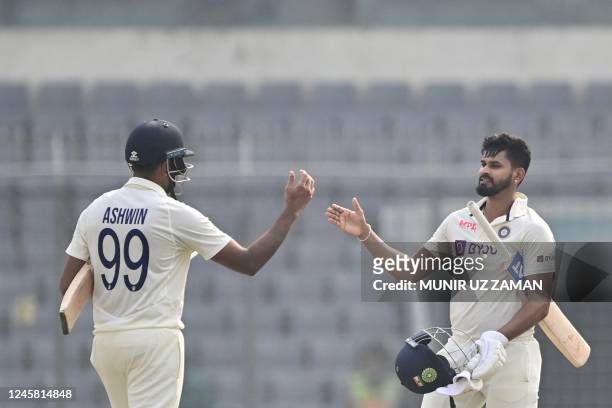 India's Shreyas Iyer celebrates with teammate Ravichandran Ashwin after winning on the fourth day of the second cricket Test match between Bangladesh...