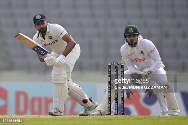 India's Shreyas Iyer plays a shot as Bangladesh's wicketkeeper Nurul Hasan watches during the fourth day of the second cricket Test match between...