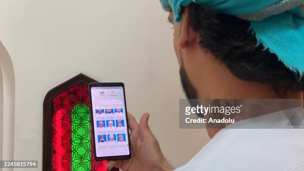 Citizens use their votes by phone as part of online voting system during local elections in Muscat, Amman on December 25, 2022.