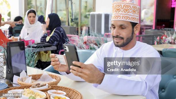 Citizens use their votes by phone as part of online voting system during local elections in Muscat, Oman on December 25, 2022.